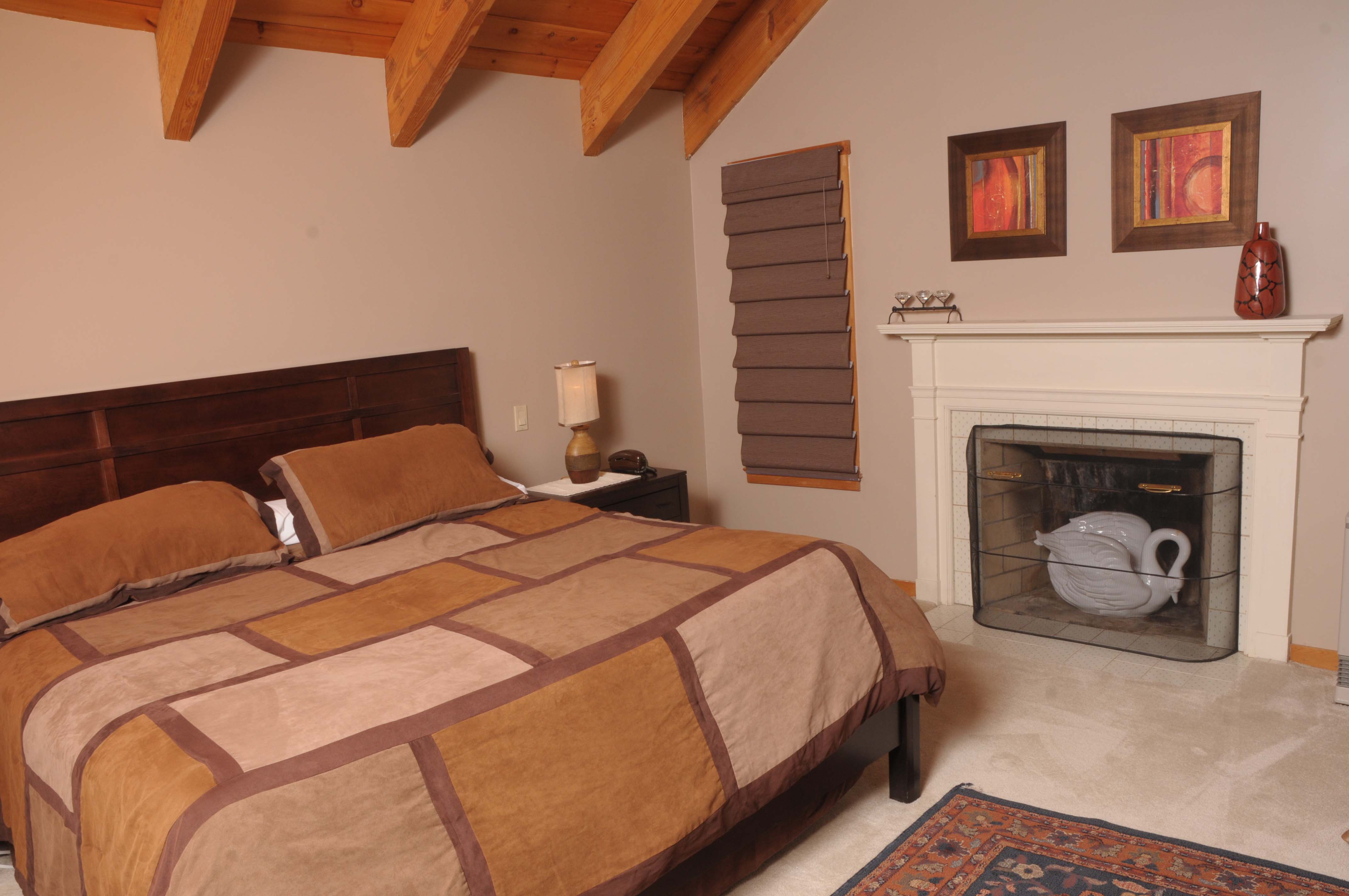 The Commons & Spruce Creek bedroom with fireplace