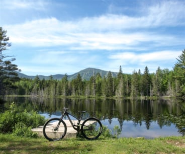Bike resting against the dock at the Moose Bog with scenic Sugarloaf Mountain in the distance