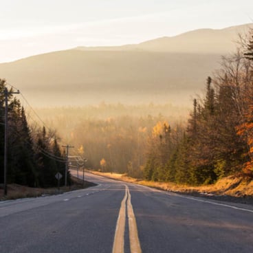 road with mountain in distance